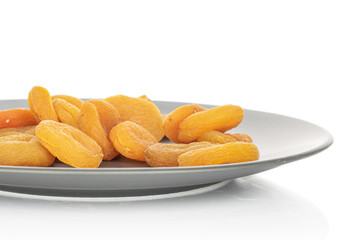 Lot of whole dried orange apricot heap in glazed bowl isolated on white background