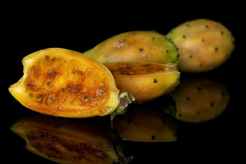 Group of two whole two halves of prickly green opuntia isolated on black glass