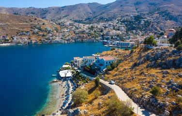 Simy island Bay with a bird's eye view, with ships, houses, city and waterfront. Popular tourist destination near the island of Rhodes, Greece, Europe