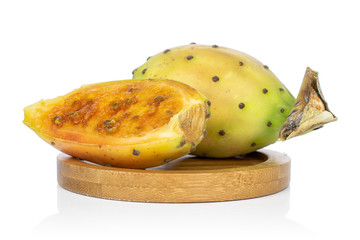 Group of one whole one half of prickly green opuntia on round bamboo coaster isolated on white background