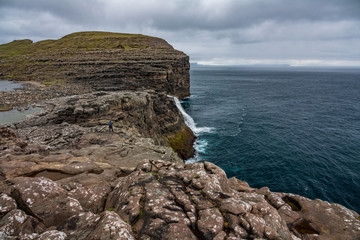 Bosdalafossur waterfall to the ocean on Faroe Islands coastline