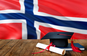 Bouvet Islands education concept. Graduation cap and diploma on wooden table, national flag background. Succesful student.