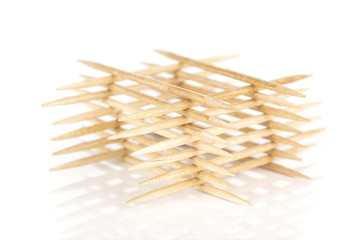 Lot of whole wooden brown toothpick tower isolated on white background