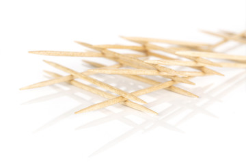 Lot of whole arranged wooden brown toothpick isolated on white background