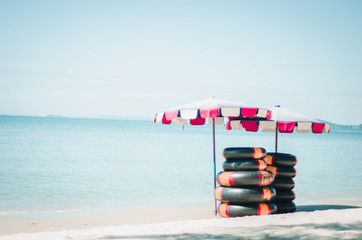 Rubber ring and quiet beach umbrella Background of summer holiday and holiday concept Inspiring tropical landscape designs Tourism and travel design, luxury beach resort scene with copy space