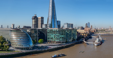 Fototapeta premium Aerial cityscape of the Thames river on a sunny day with the City Hall,skyscraper and London skyline.