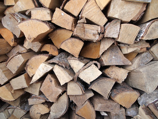 Birch firewood stacked in the woodpile, in several rows. Rural life, fuel for stoves.