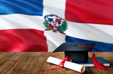 Dominican Republic education concept. Graduation cap and diploma on wooden table, national flag...