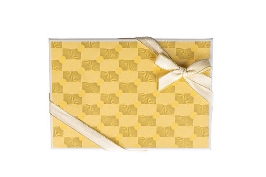 Yellow luxury gift present box with pattern, ribbon and rosette. Top view from above isolated on white background.