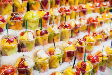 Fototapeta na wymiar Fresh fruit snacks on stand in ice