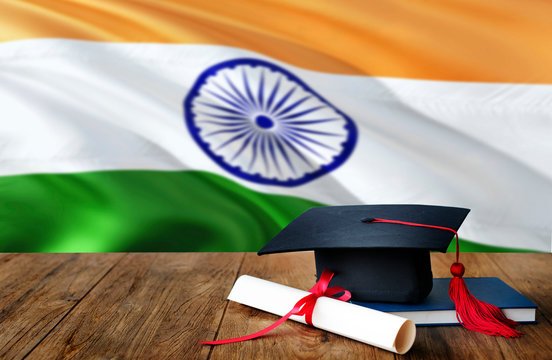 India Education Concept. Graduation Cap And Diploma On Wooden Table, National Flag Background. Succesful Student.