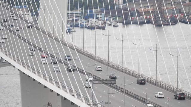 Russky Bridge from Russky Island to mainland Vladivostok. Russian Bridge from Russian Island. A lot of cars are going in different directions
