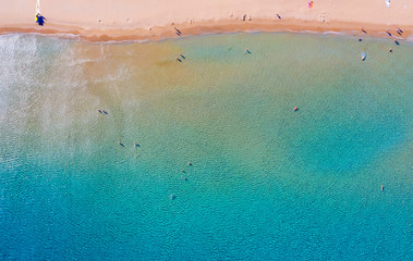 texture of sea with clear turquoise water and bottom top view with the drone. iridescent yellow blue colors