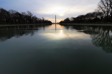 Daybreak vista looking across the Reflecting Pool towards the Washington Monument, National Mall, Washington DC