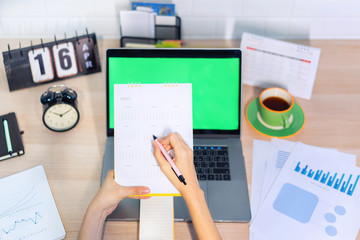 Woman planning agenda and schedule using calendar event planner. Calender planner organization management remind concept.