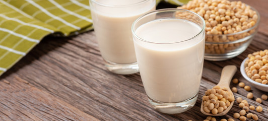 Homemade Soy milk and Soybean on wooden background, Healthy drink. Copy space and Horizontal photo banner background.