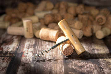 Fototapeta na wymiar corkscrew and corks on wooden background