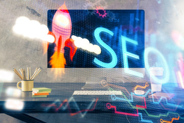 Multi exposure of table with computer and seo drawing hologram. Search optimization concept.