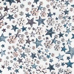 Blue stars and snowflakes pattern on white background. Top view. Creative holiday concept. Flat lay. White blue colors. Winter layout