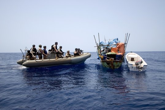 U.S. Navy and Coast Guard counter piracy personnel approach a suspect vessel while under way