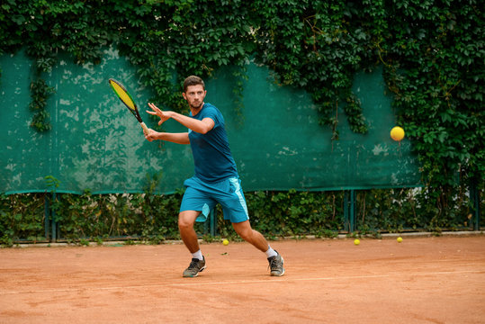 Young tennis player practicing at outdoor court.