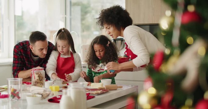 Family making yummy cookies for Christmas 