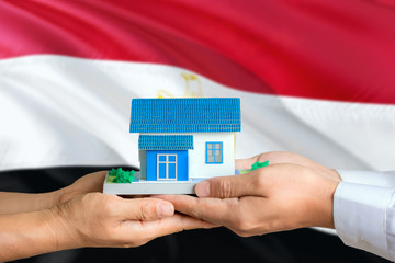 Egypt real estate concept. Man and woman holding miniature house in hands. Citizenship theme and...