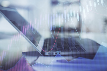 Forex graph hologram on table with computer background. Double exposure. Concept of financial markets.
