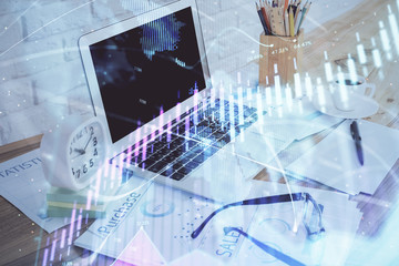 Stock market chart hologram drawn on personal computer background. Double exposure. Concept of investment.