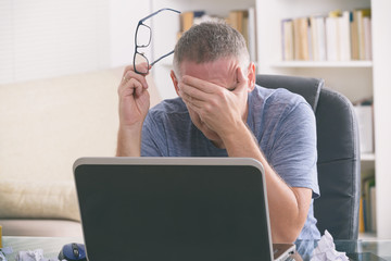 Tired and overworked freelancer at his working place