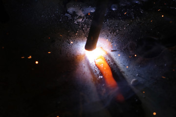 Welding metal macro background. Industrial welding light sparks.