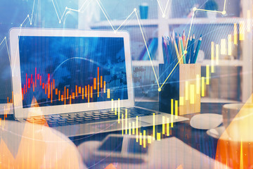 Financial chart drawing and table with computer on background. Double exposure. Concept of international markets.