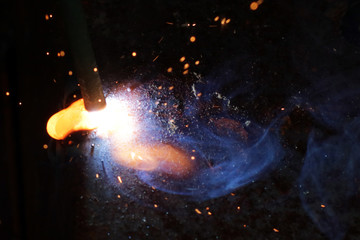 Fototapeta na wymiar Welding metal macro background. Industrial welding light sparks.