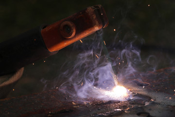 Welding metal macro background. Industrial welding light sparks.