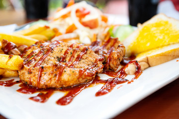 Grilled pork steak with salad on a plate