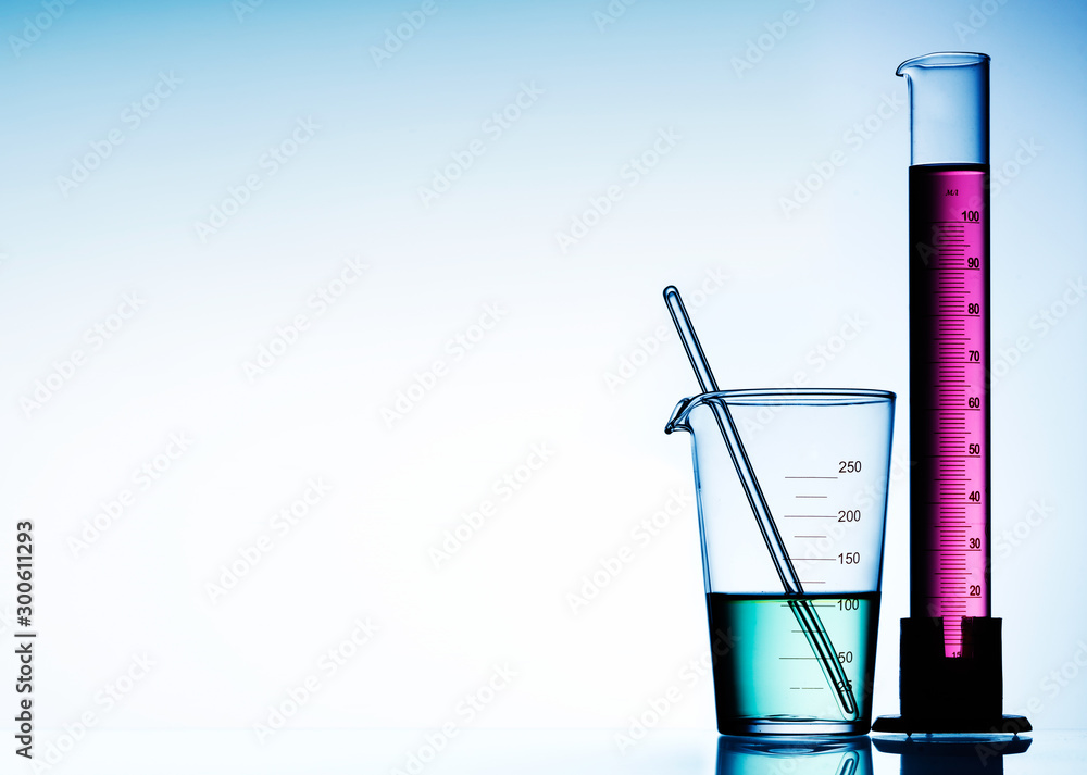 Wall mural different laboratory glassware with color liquid and with reflection