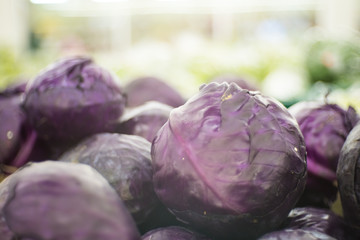 Fototapeta na wymiar Closeup of purple cabbage with vegetables on table at supermarket.