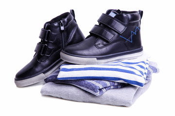 stack of children's sweatshirts and boots