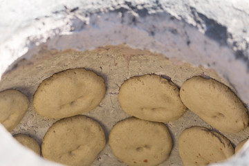 Cakes are baked in a tandoor, close-up