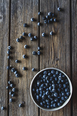 Bowl of blueberries on a wooden background. Healthy food, health