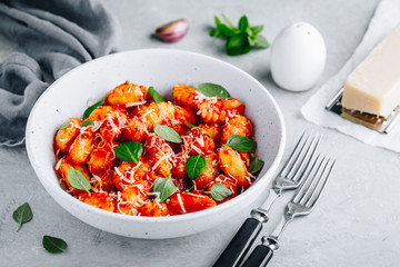 Traditional Italian potato Gnocchi with tomato sauce, parmesan cheese and fresh basil