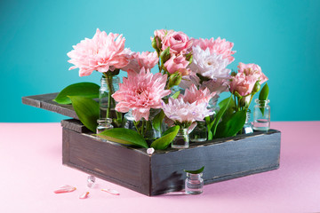 wooden box with rose flowers on blue and pink background