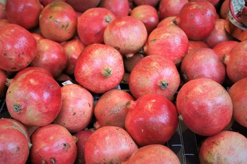 closeup of red pomegranates on display at the market