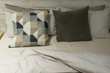 Modern fabric pillows checkered pattern on blue fabric sofa interior decoration