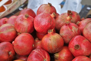 closeup of red pomegranates on display at the market