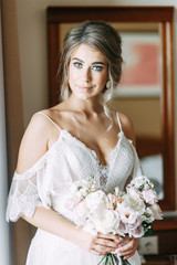 Fototapeta premium Stylish European style wedding in the hallway. Happy bride at the hotel.