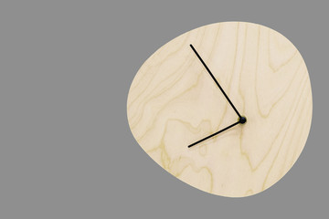 Wooden clock without a dial on a gray background.