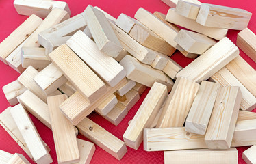 Wooden blocks on a pink background. Pile of wooden boards.