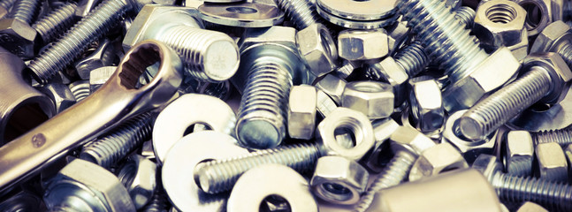 Abstract industrial background. Bolts and nuts. Many metalware. - obrazy, fototapety, plakaty