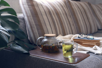 Interior living room, sofa, herbal tea, plaid, book,
